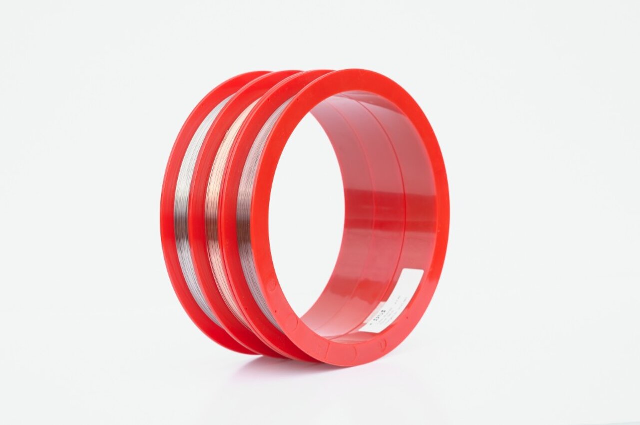 Three red supply spools holding fine laser welding wire